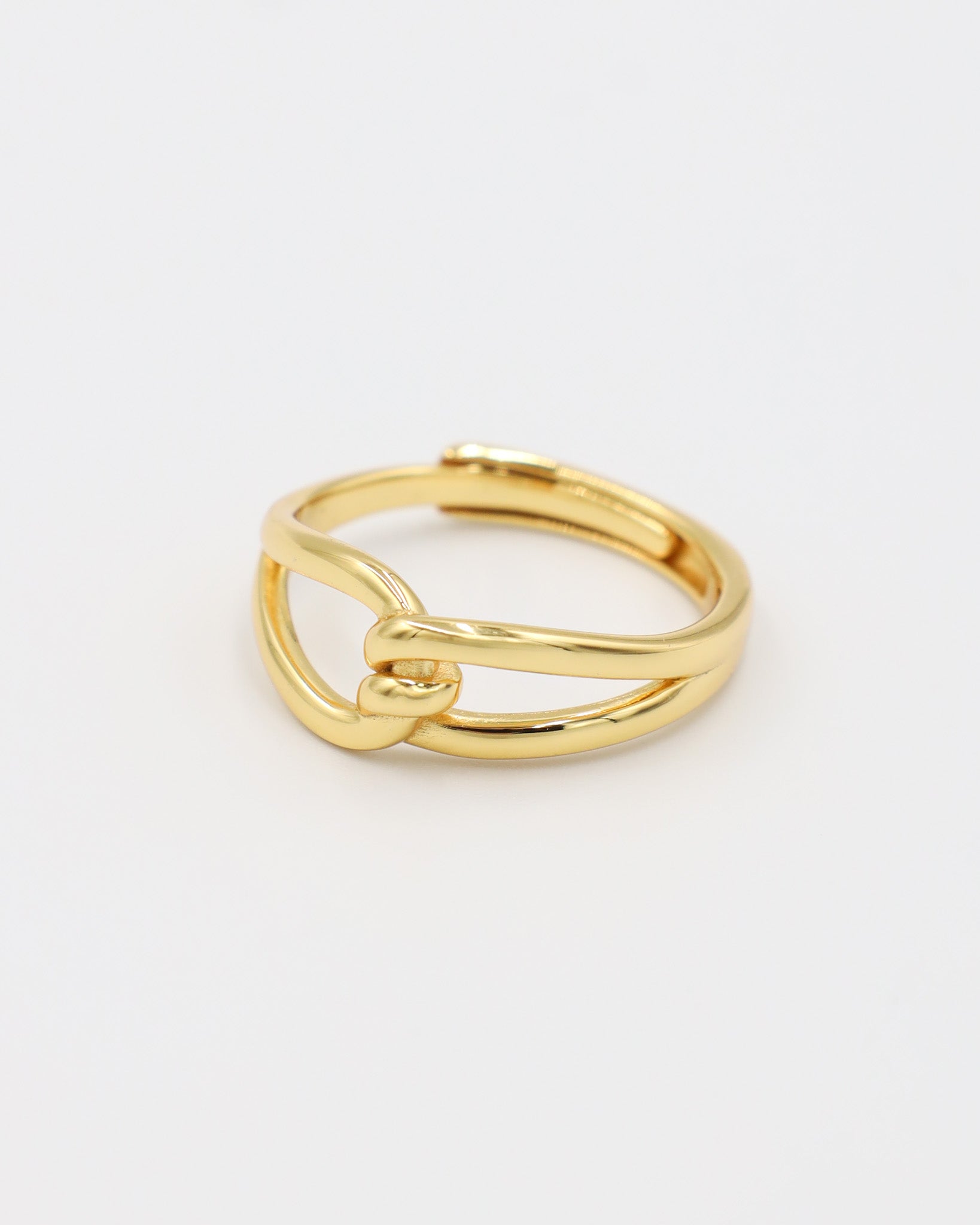 A gold-colored ring with a simple design, featuring two loops that are not connected.