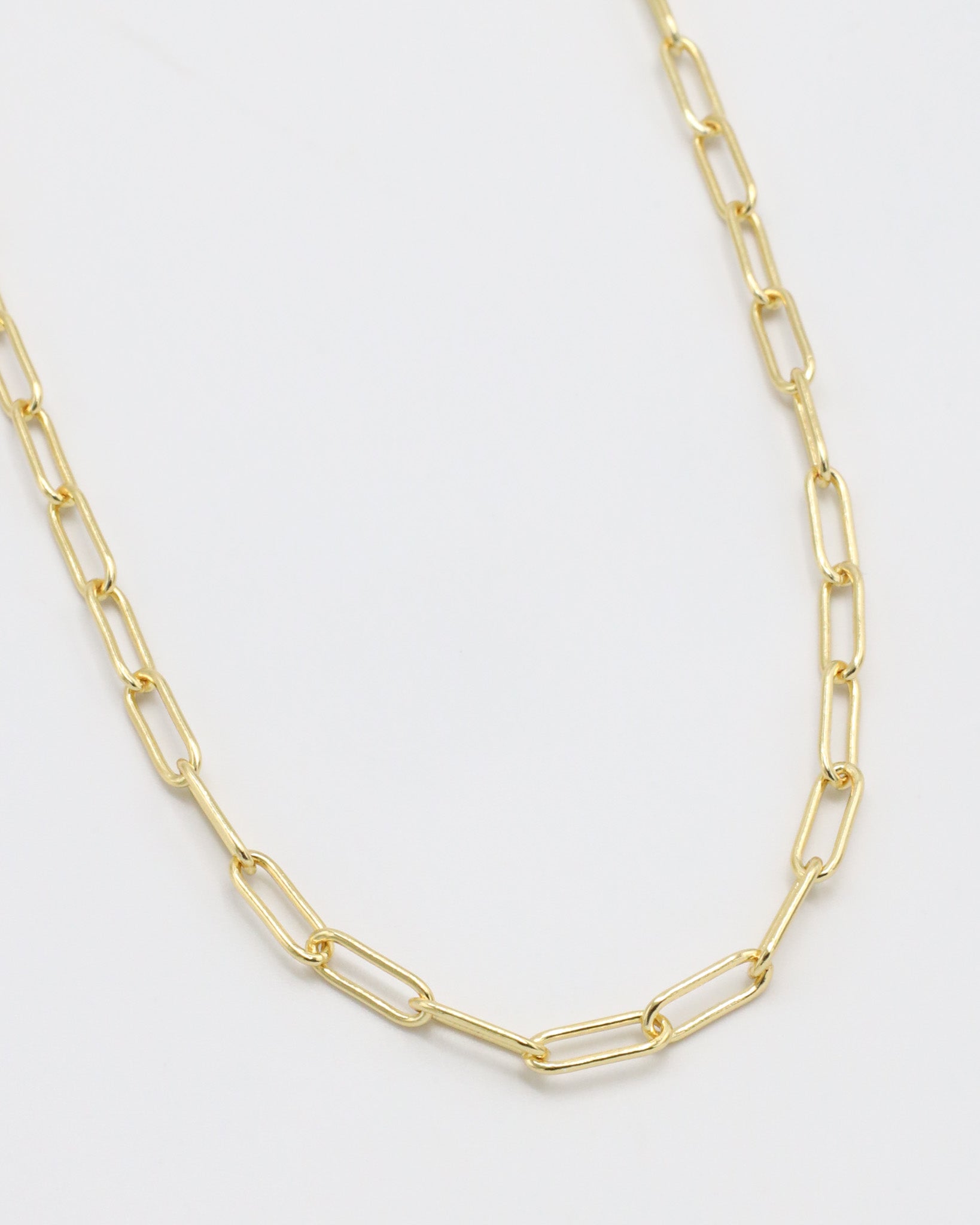 Gold chain necklace on a white background