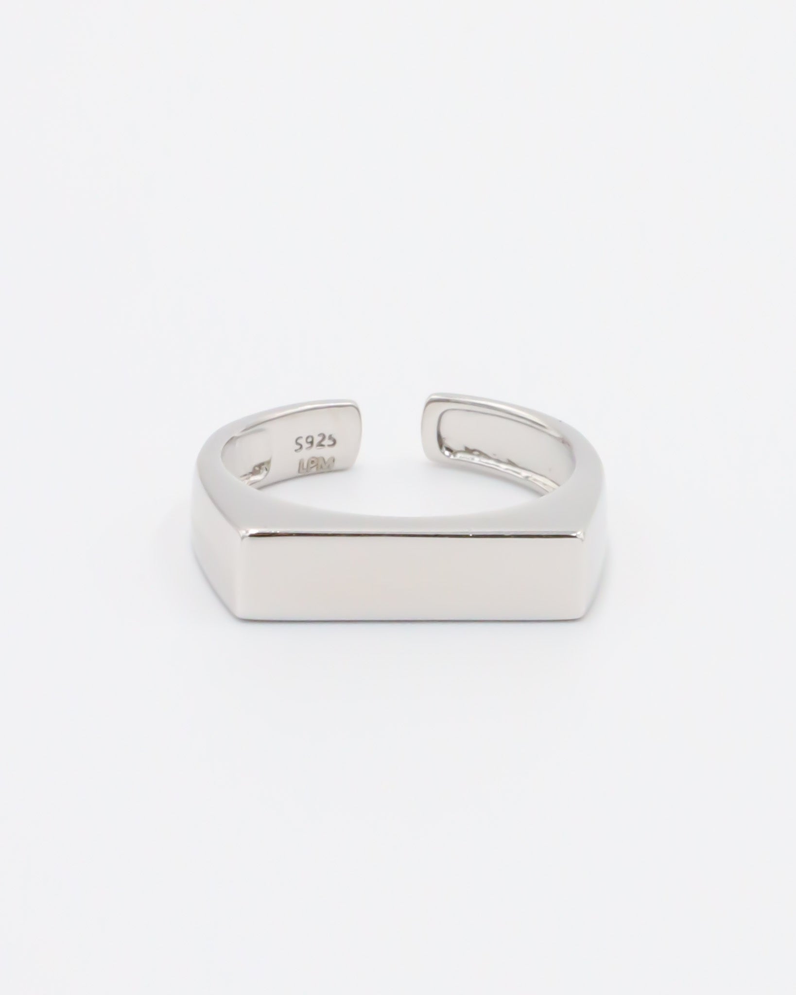 An adjustable silver ring with a rhodium finish and a rectangular bar design.