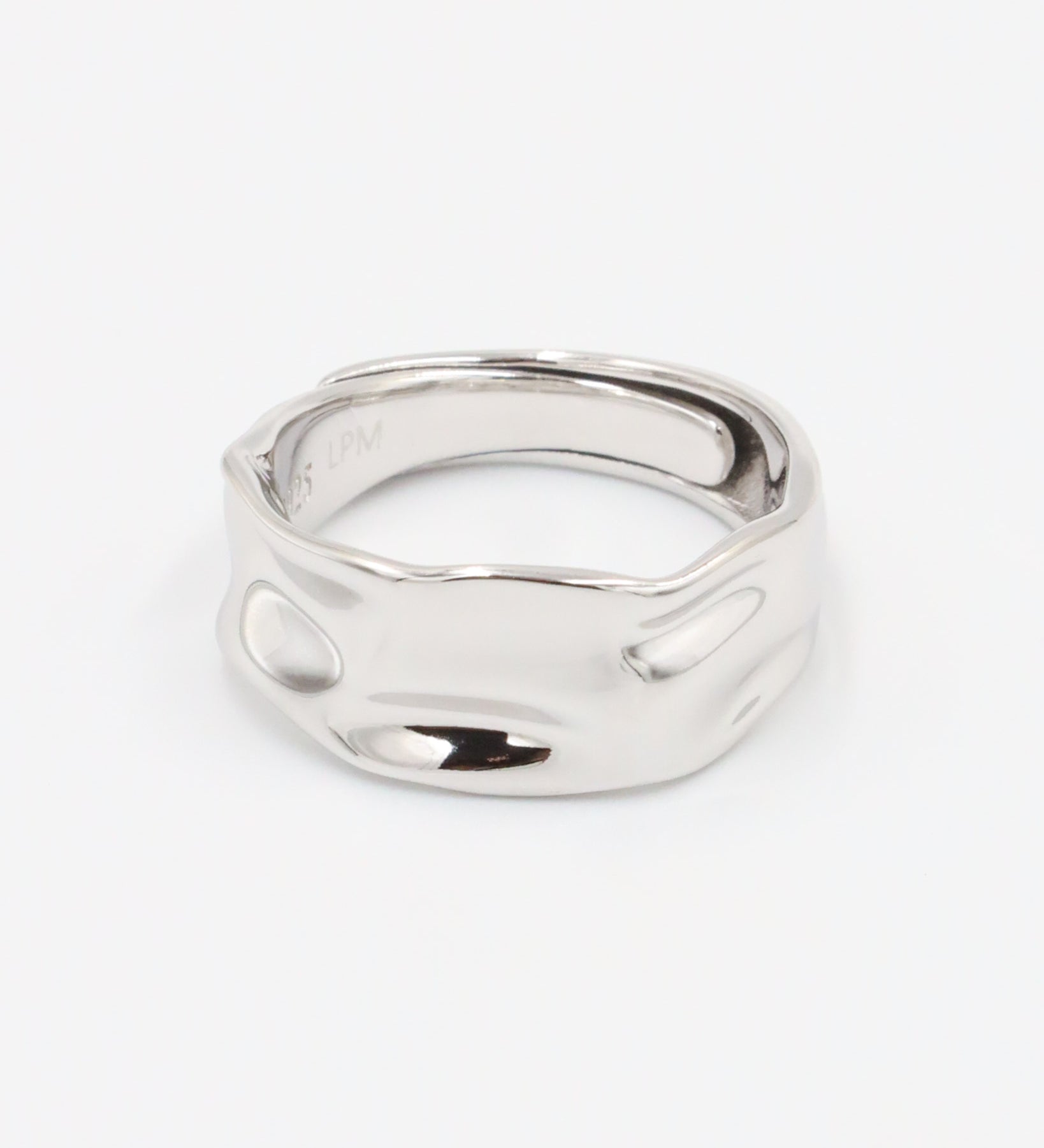 A silver ring with a simple, elegant design on a white background.
