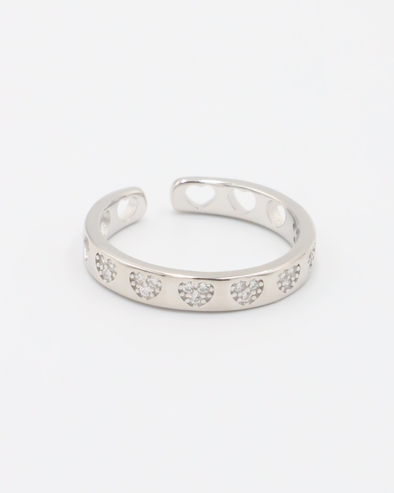 A silver ring with multiple clear stones set in an open band design.