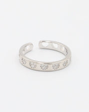 A silver ring with multiple clear stones set in an open band design.