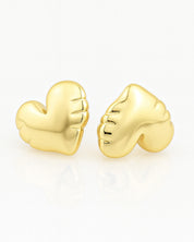 Gold heart-shaped earrings on a white background