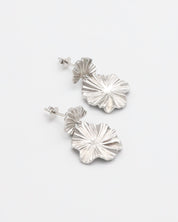 A pair of silver stud earrings with a butterfly clasp and floral design