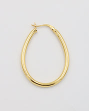 A single gold creole earring with a latch back clasp on a white background.