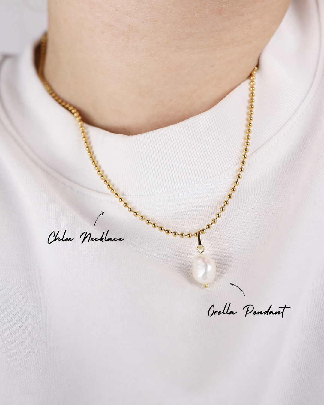 Gold necklace with a pearl pendant on a white background