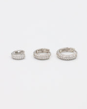 Three sizes of Billie hoop earrings in silver with zirconia stones, displayed from a top view. Sizes shown: S, M, and L.
