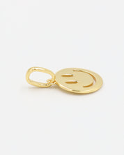 Flynn Gold smiley face pendant made of gold-plated 925 sterling silver, shown close-up with side view.
