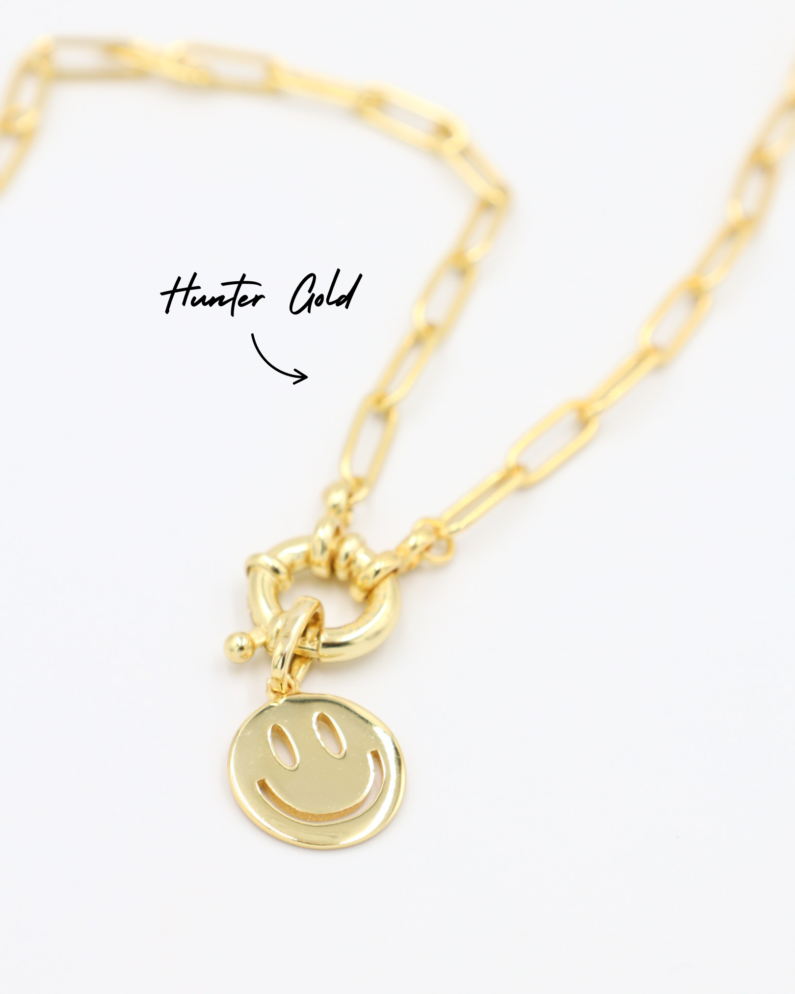Close-up of Hunter Gold chain necklace featuring Flynn Gold smiley face pendant in gold-plated 925 sterling silver.