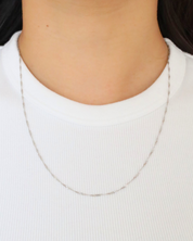 Woman wearing the delicate Jamie Silver necklace, made from 925 sterling silver.