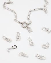 Sterling silver alphabet pendants adorned with zirconia stones, displayed with a chain.