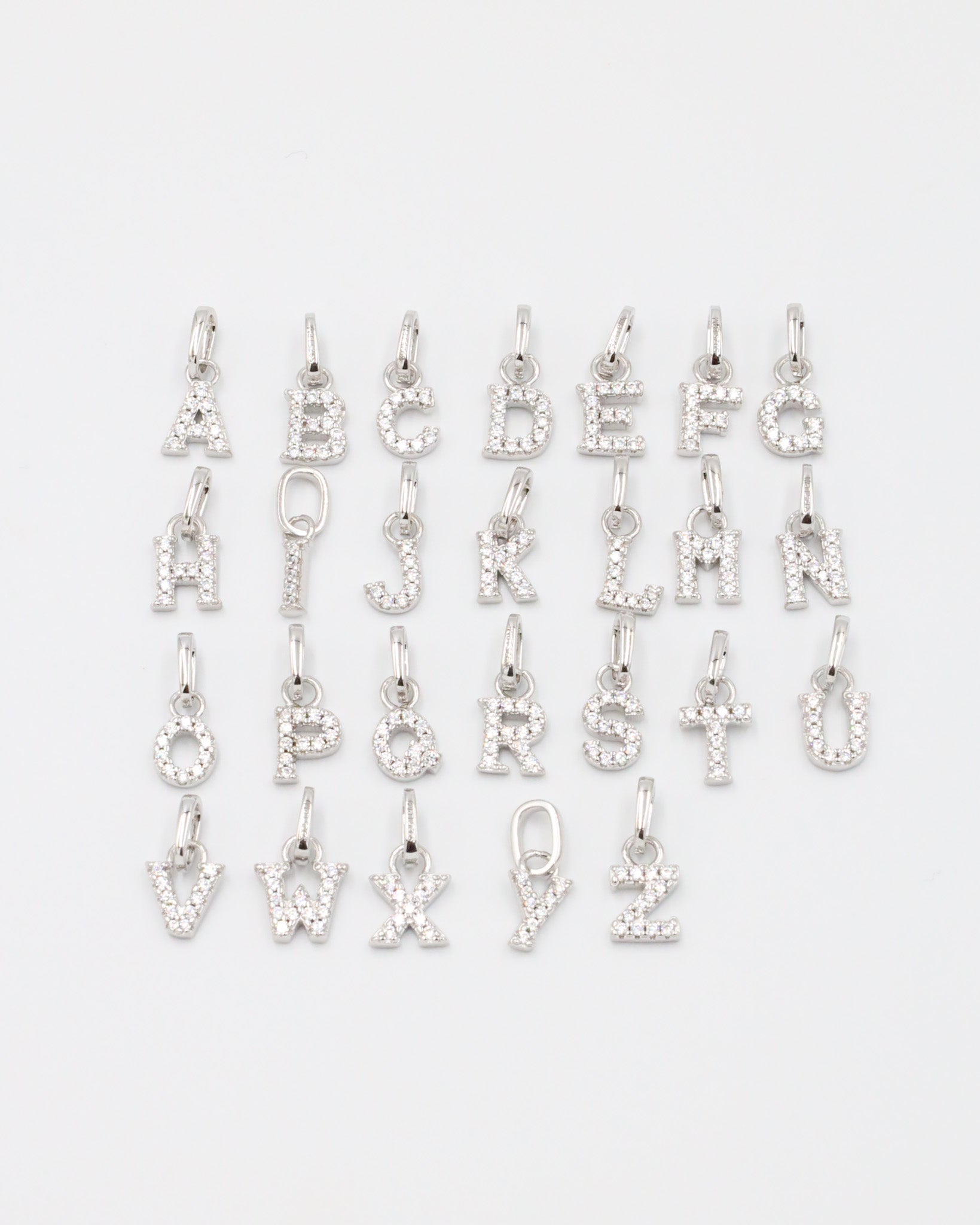 Personalized sterling silver letter pendants with zirconia.