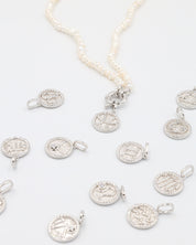 Elegant Zodiac silver pendant set, highlighting all astrological signs in rhodium-plated sterling silver with zirconia stones.