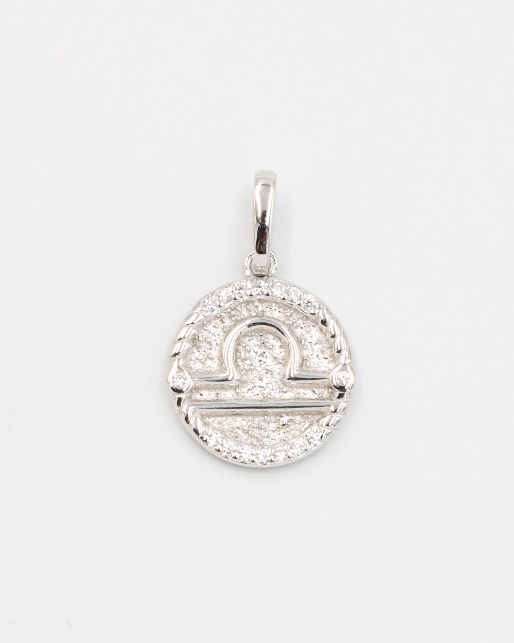 Libra zodiac silver pendant in rhodium-plated sterling silver featuring a detailed design and zirconia stones.