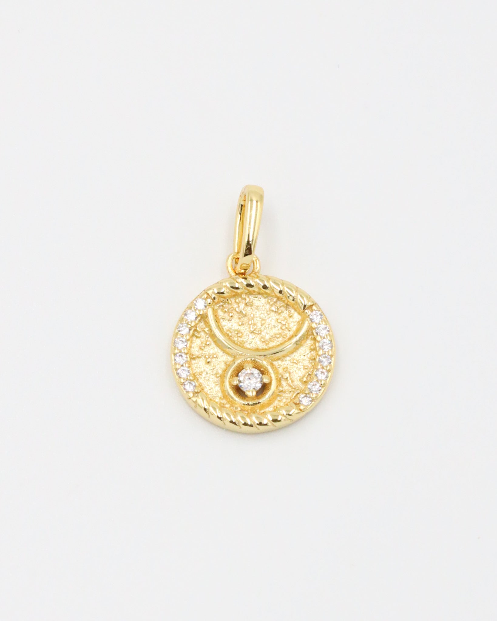 Gold-plated sterling silver Taurus zodiac pendant with sparkling zirconia stones.