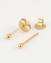 Gold earring components on a white background