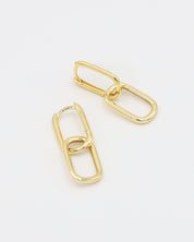 A pair of gold-colored hoop earrings with a hinged clasp, displayed against a white background.