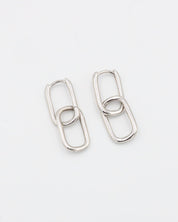A pair of silver hoop earrings with a hinged clasp, displayed against a white background.