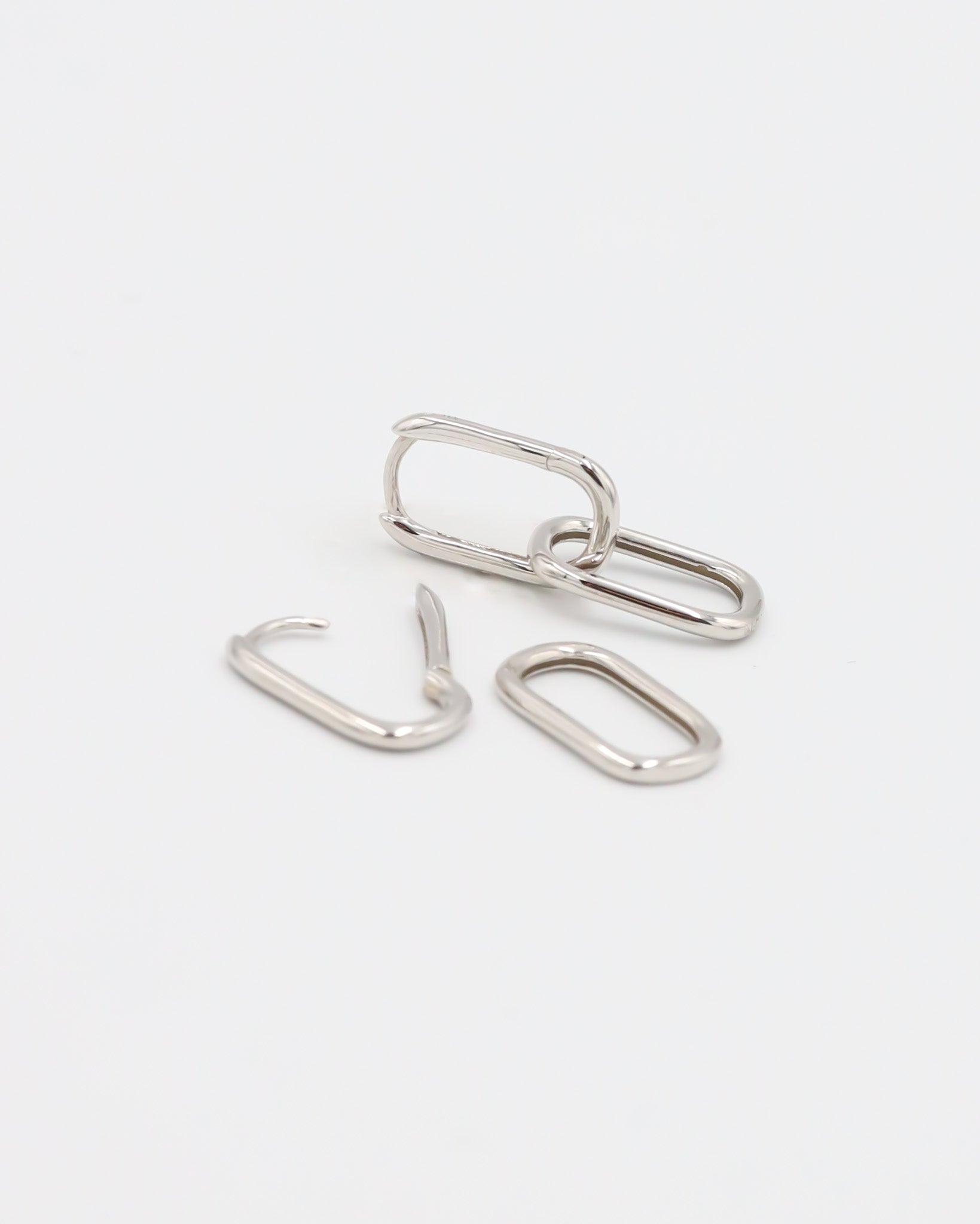 Adelaide earring in silver, shown disassembled with one hoop and two detachable rectangular pendants, displayed on a white background.