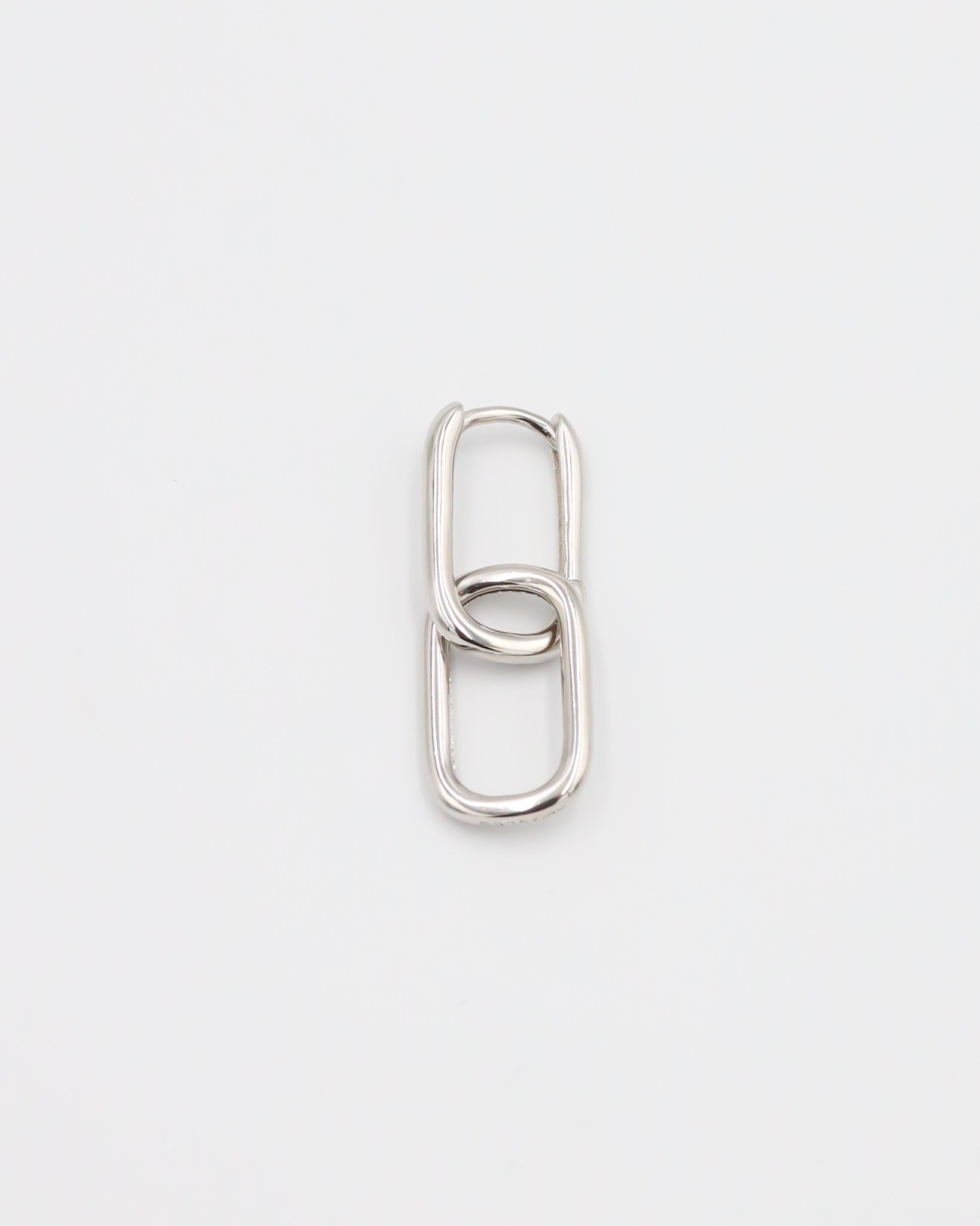 Close-up of a single Adelaide earring by ruru. studios, featuring a modern double-link design in a polished silver finish.