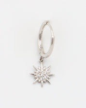A silver hoop earring with a star-shaped charm attached to it, displayed against a white background.
