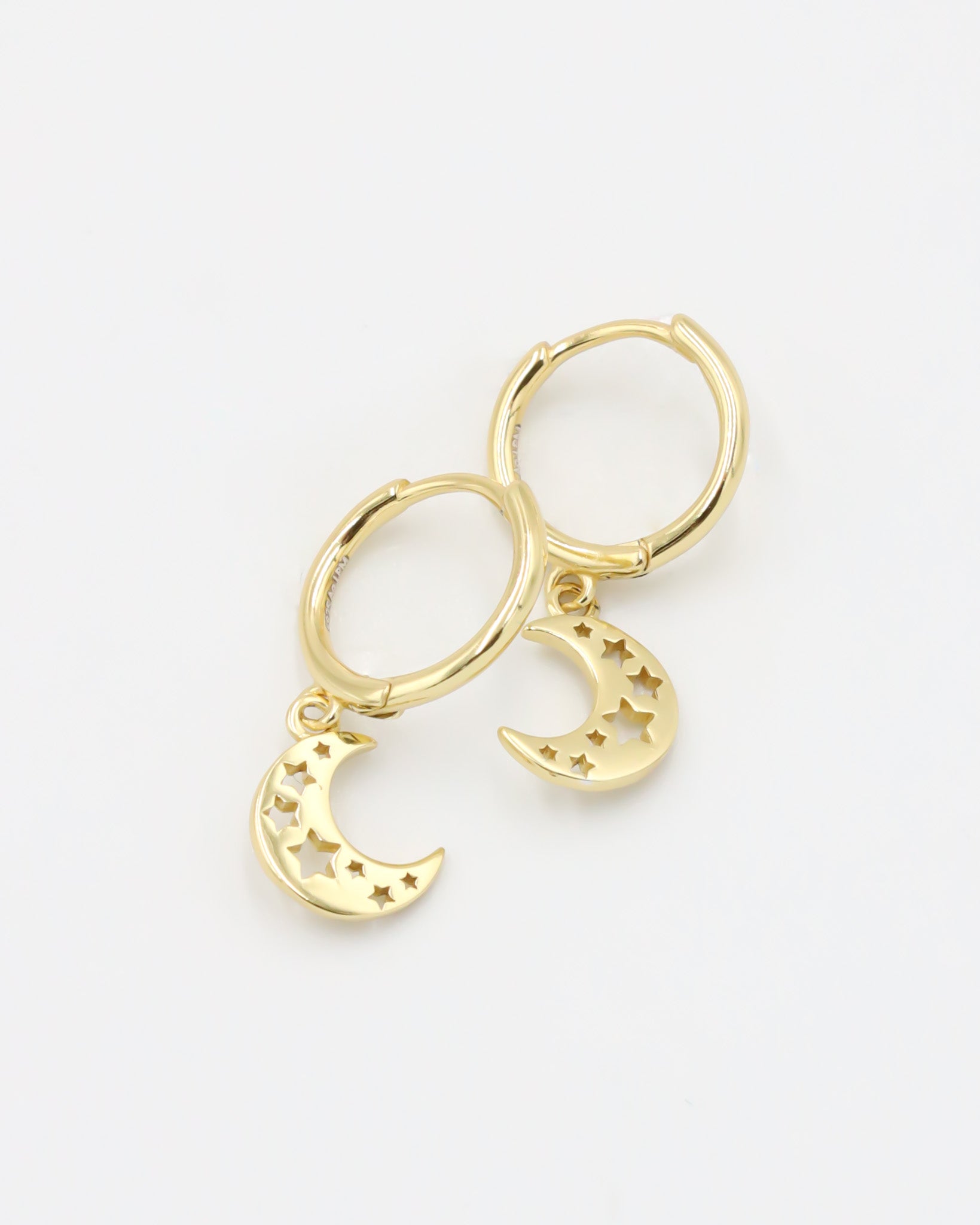 A gold-colored hoop earring with a crescent moon charm attached, set on a white background.