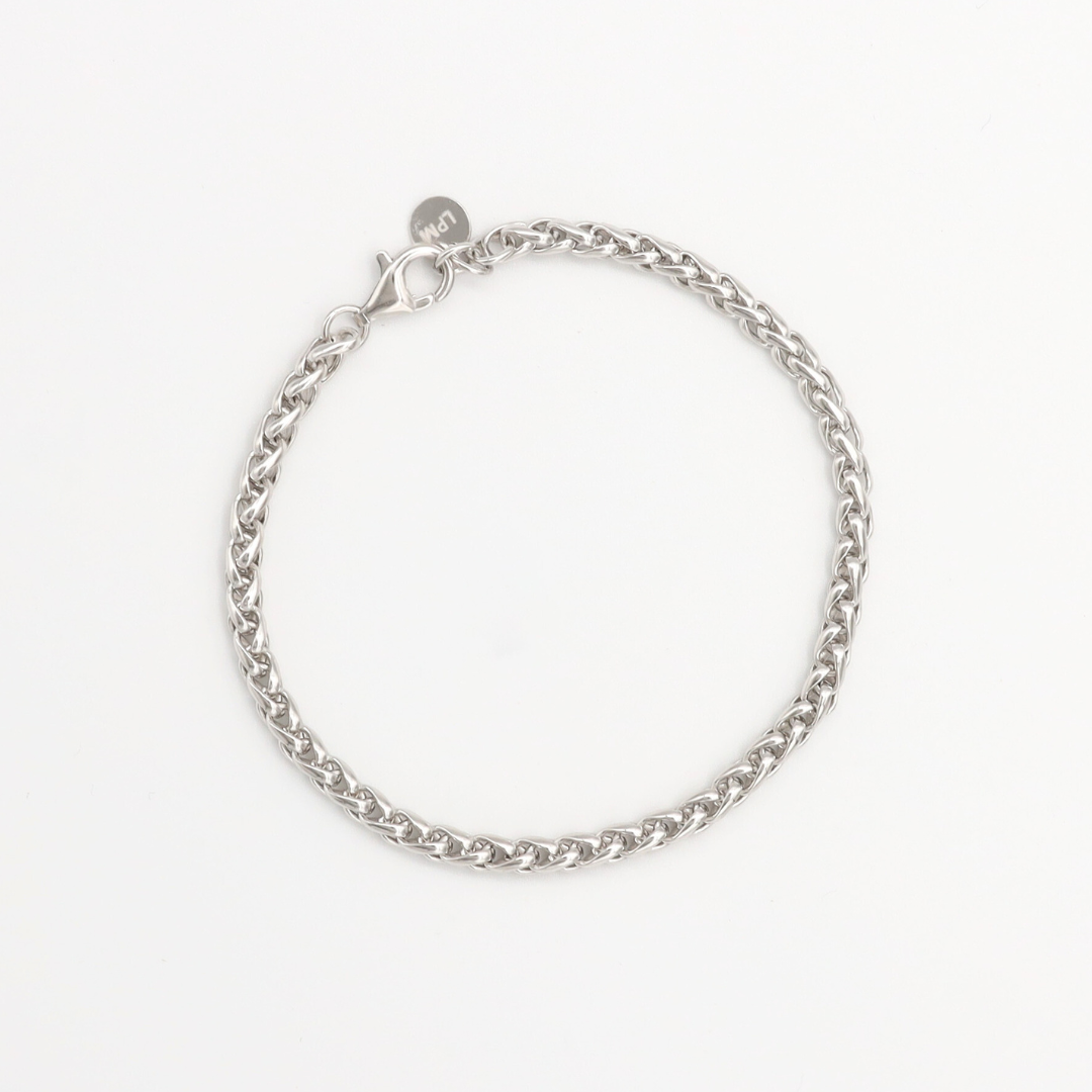 A silver-colored bracelet with a clasp, displayed against a white background.