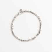 A silver-colored bracelet with a clasp, displayed against a white background.