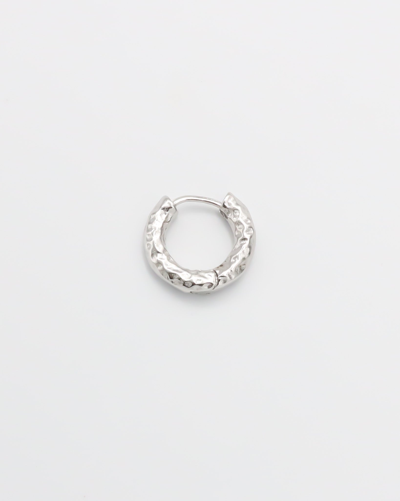 A single silver hoop earring with a hinged clasp, displayed against a white background.