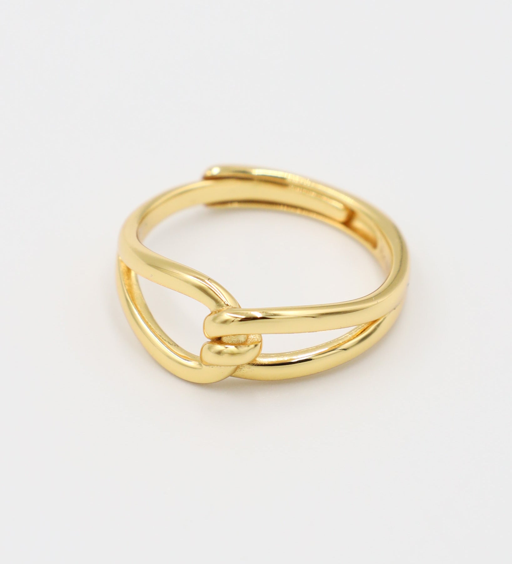 A gold-colored ring with a simple design, featuring two loops that are not connected.