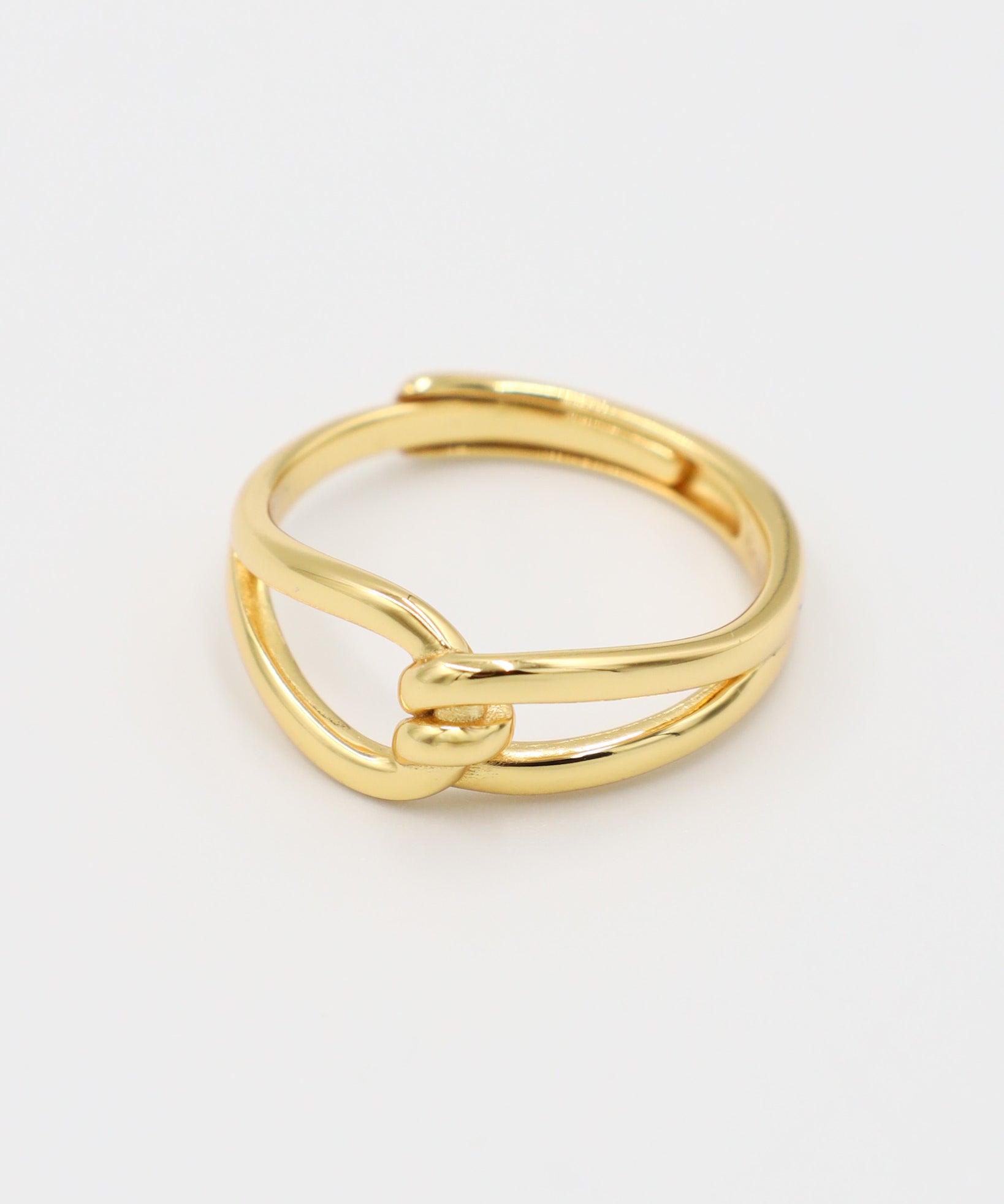 A gold-colored ring with a simple design, featuring two loops that are not connected.