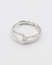 A simple silver ring with a unique design, featuring a knot-like pattern on a white background.