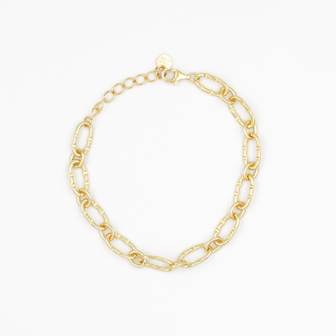 A gold-colored bracelet with a chain link design on a white background.