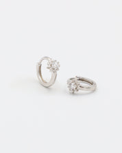 A silver hoop earring with a hinged clasp and no visible gemstone.
