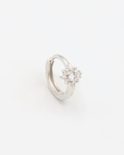 A silver hoop earring with a hinged clasp and no visible gemstone.