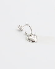 A pair of silver heart-shaped stud earrings with butterfly clasps on a white background.