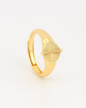 Gold ring with geometric design on a light gray background