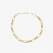 A gold-colored bracelet laid out on a plain surface.
