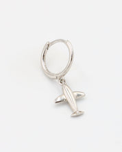 A silver hoop earring with a hinged clasp and a small airplane charm attached to it.