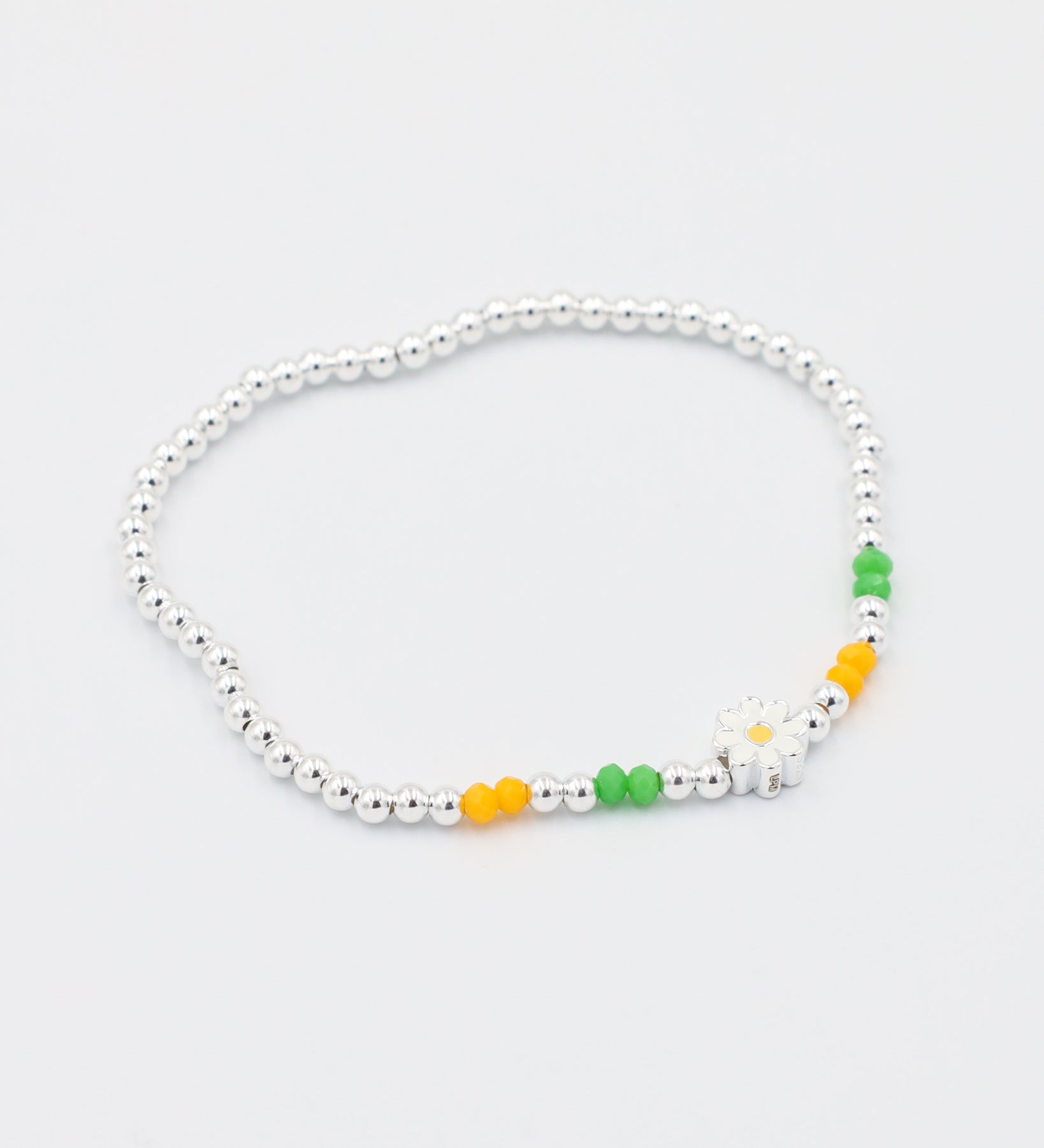 Side view of the adjustable Azalea bracelet with sterling silver beads and colorful accents, perfect for a versatile and fun look.