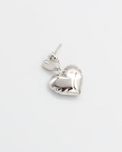 A pair of silver heart-shaped stud earrings with butterfly clasps on a white background