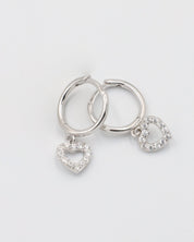 Silver hoop earrings with heart and 'O' charm on white background