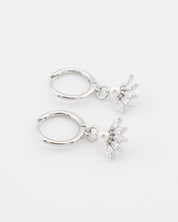 Pair of silver hoop earrings with star-shaped charms on a white background