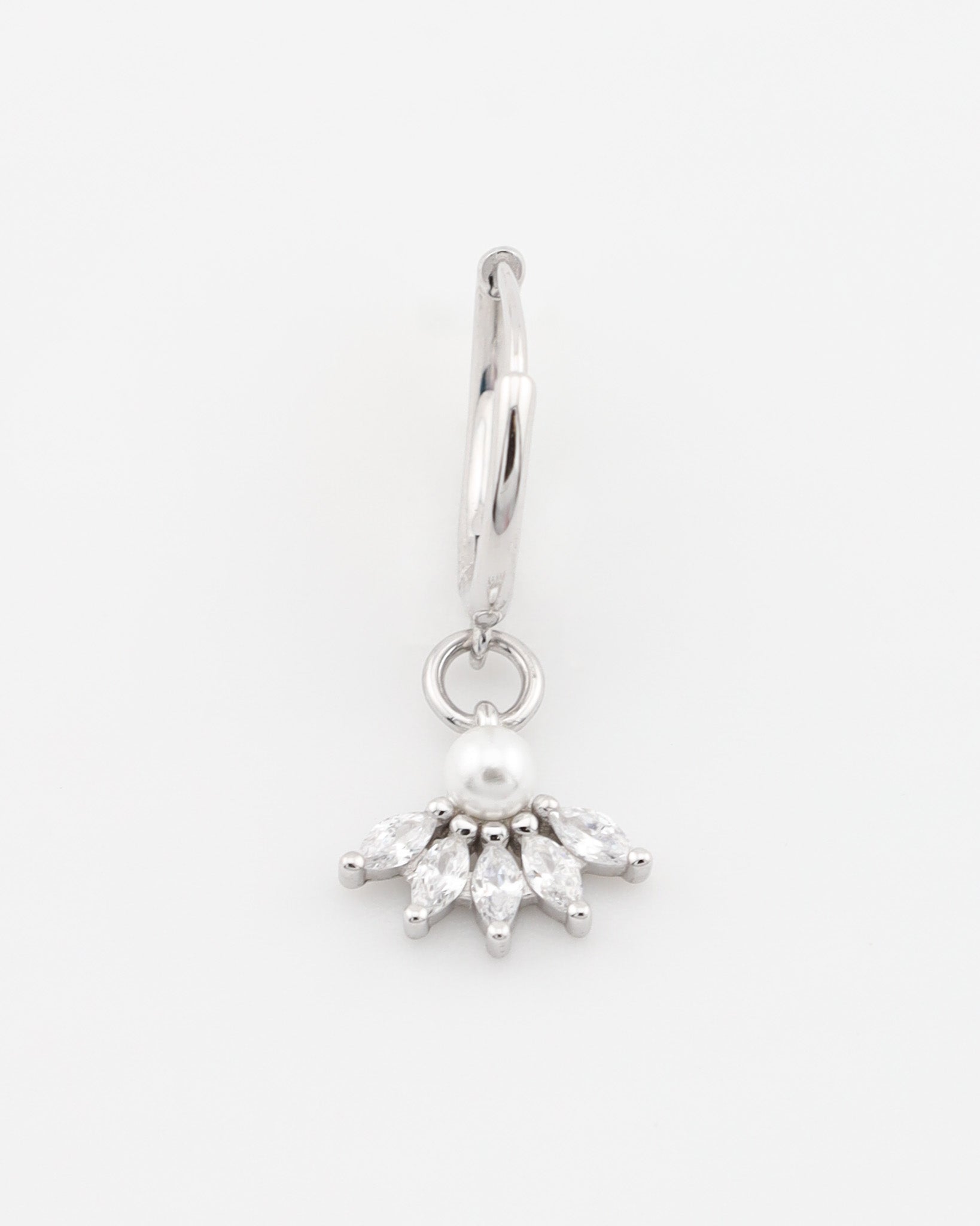 Silver earring with a pearl and clear stones on a white background