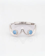 Silver ring with blue gemstones on a white background
