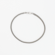 A silver necklace on a white background.