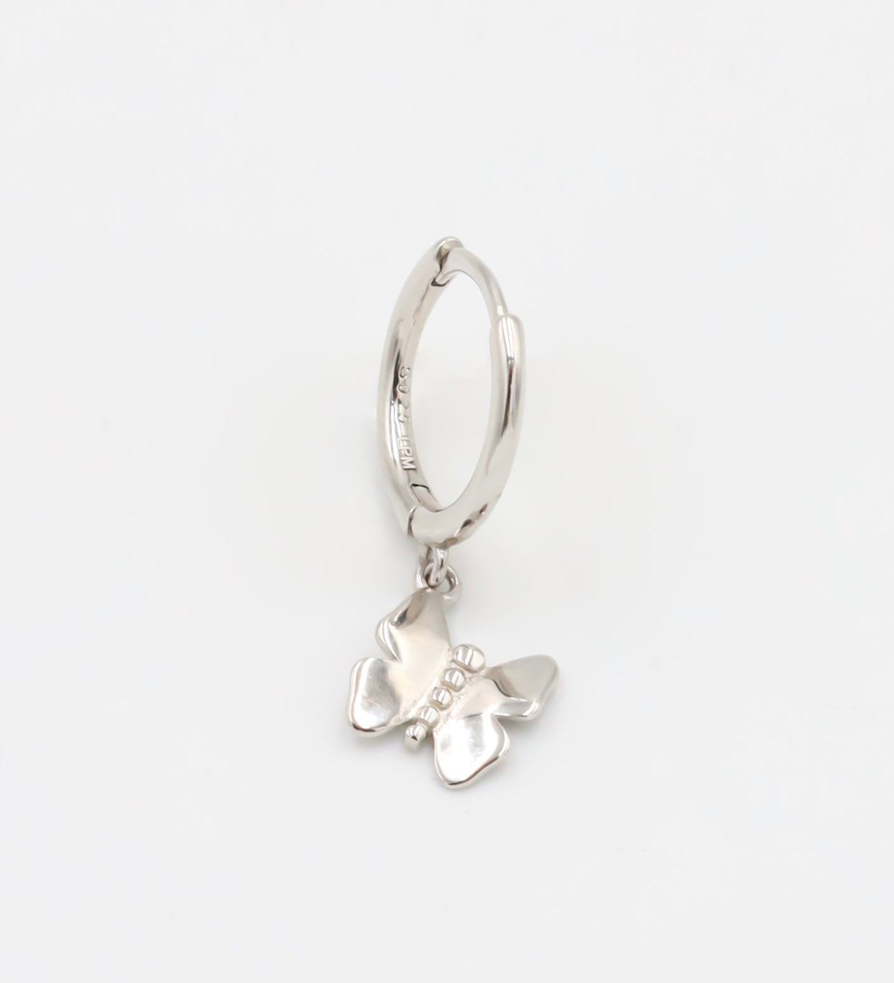 A silver hoop earring with a butterfly charm attached to it, displayed against a white background.