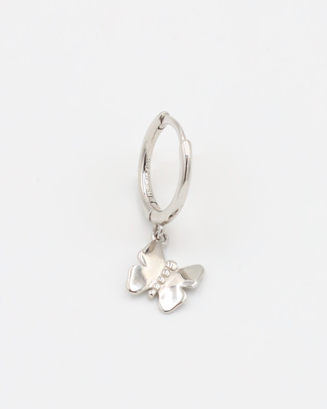 A silver hoop earring with a butterfly charm attached to it, displayed against a white background.