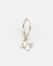 A silver hoop earring with a butterfly charm attached to it, displayed against a white background.