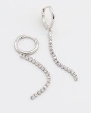 A silver hoop earring with a hinged clasp and small hanging diamonds